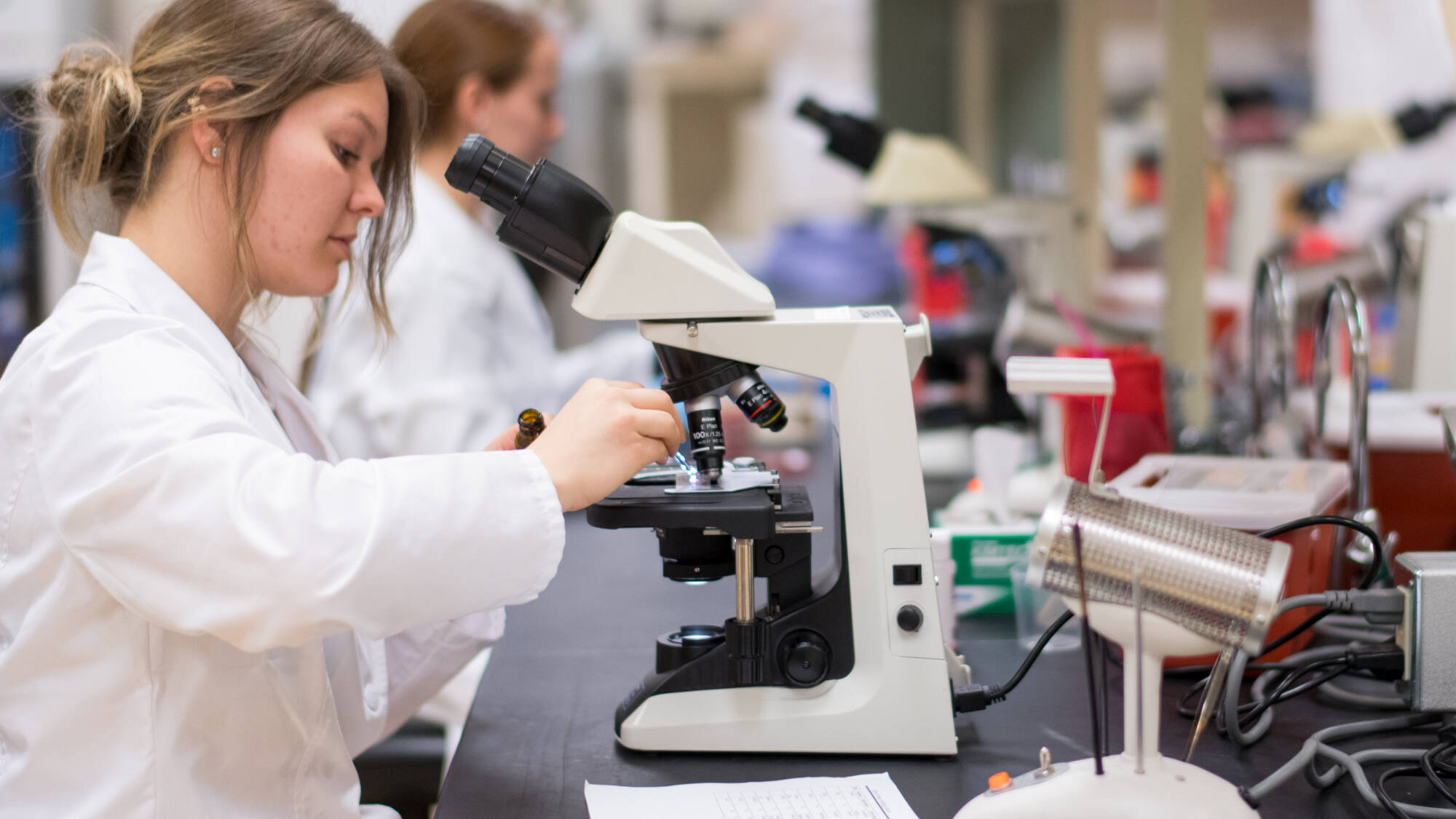 Student looking at a microscope slide.